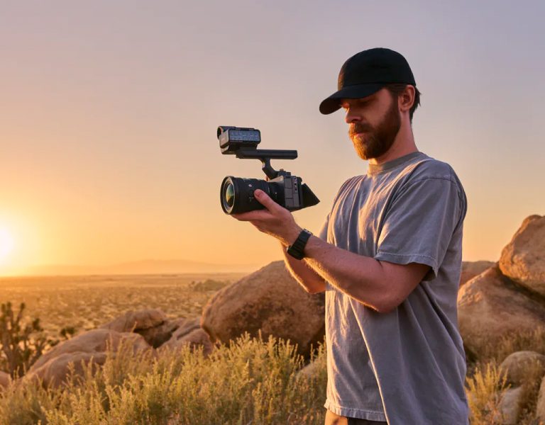 A man holding an FX5 in a desert location