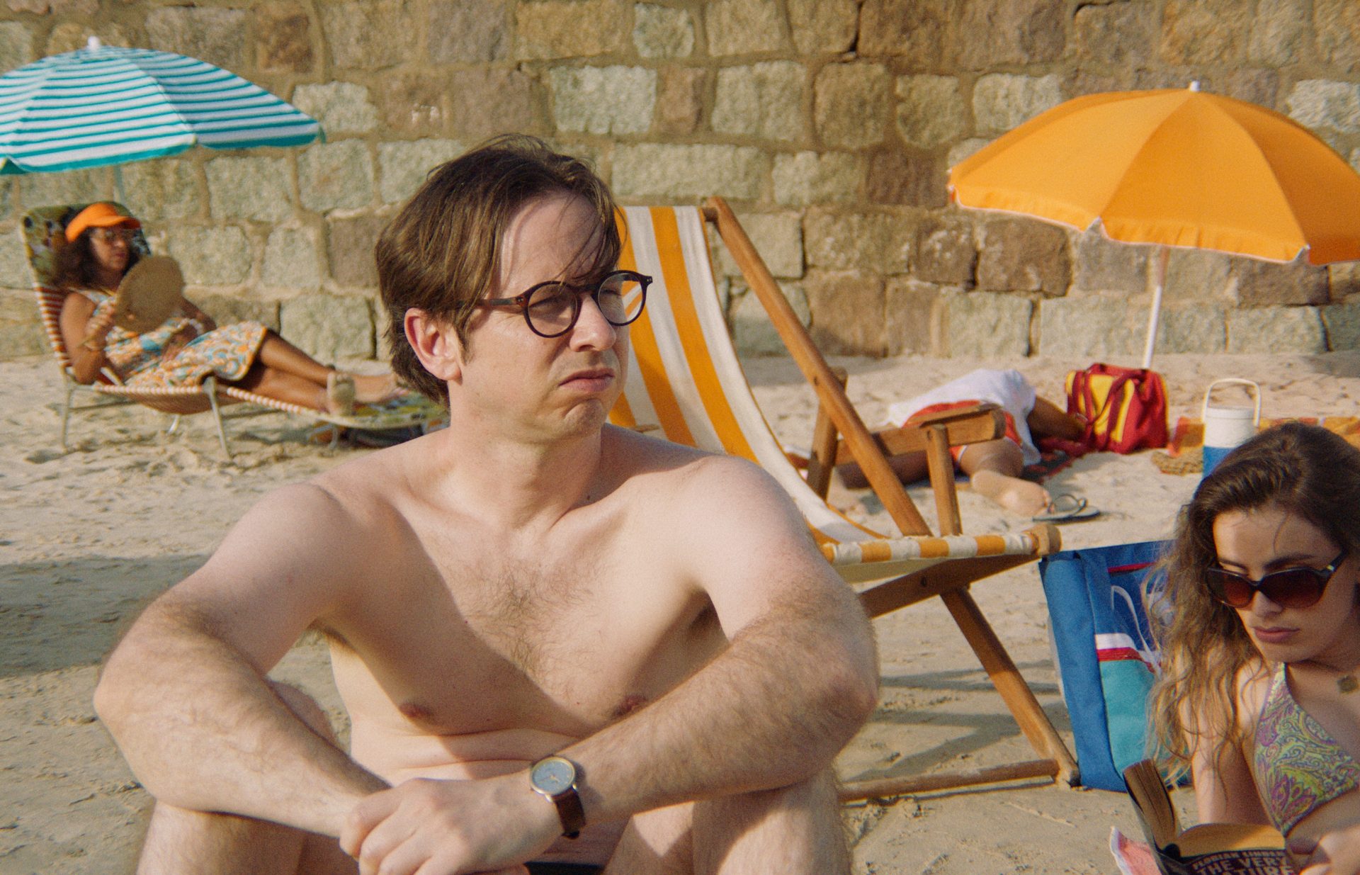 A group of people sat at the beach 