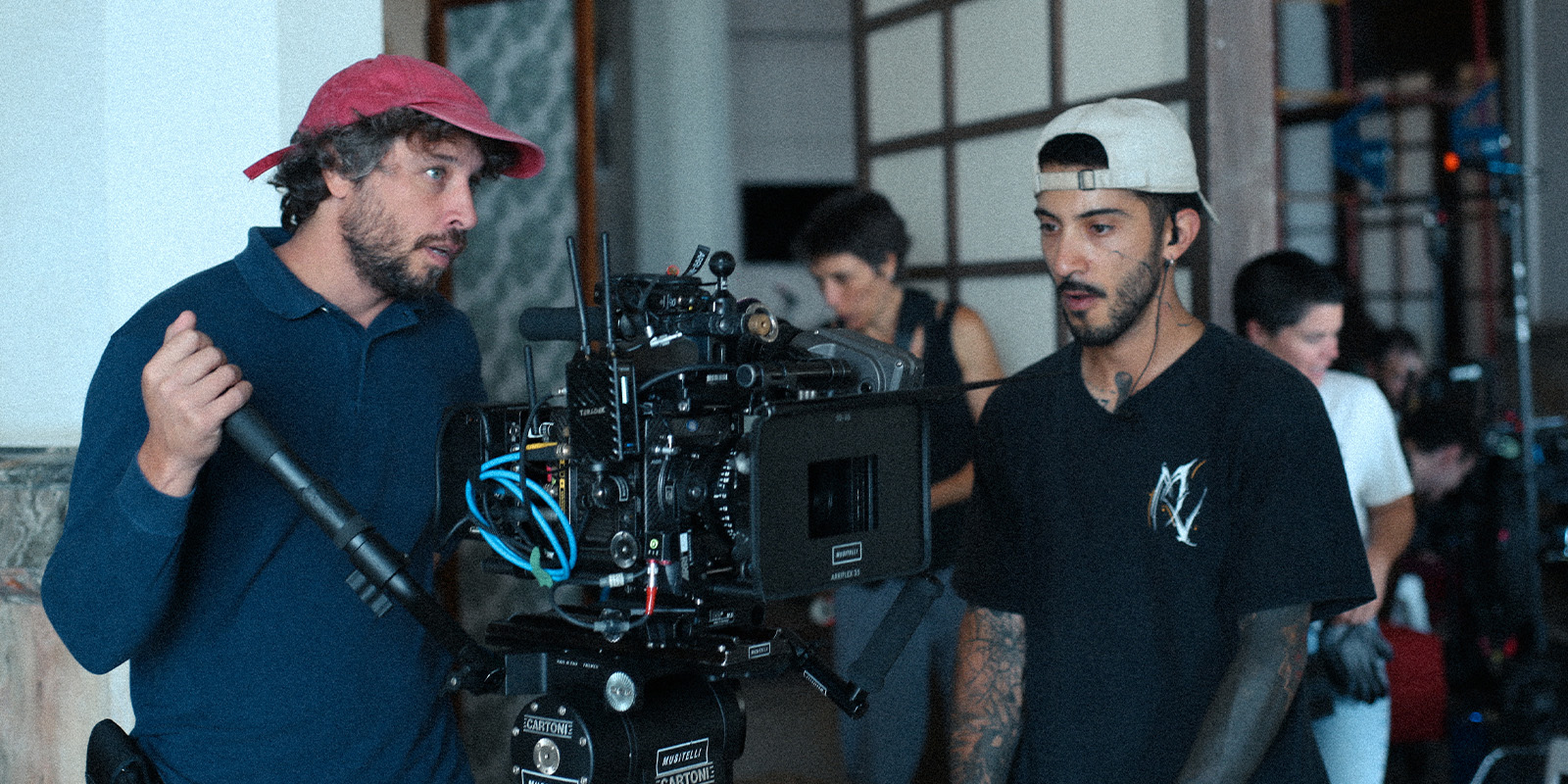 Film crew on set by a large camera
