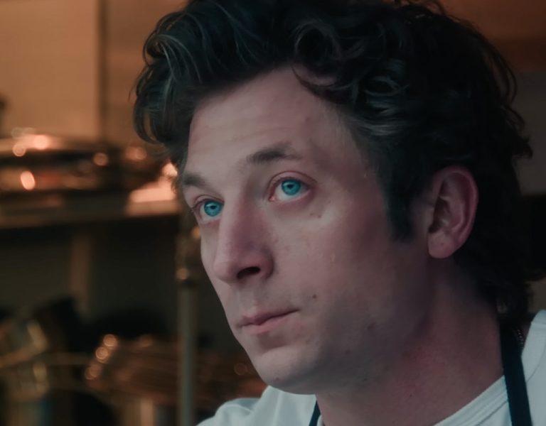 Carmy from The Bear in a kitchen looking stressed