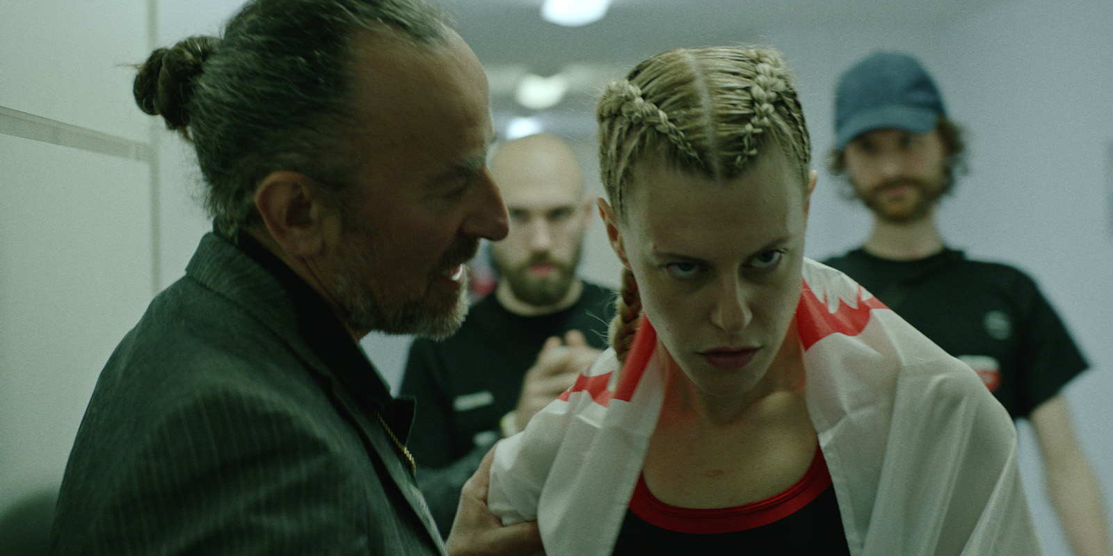People gathered in a corridor before a fight 