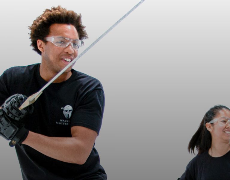 Three people wielding swords and smiling
