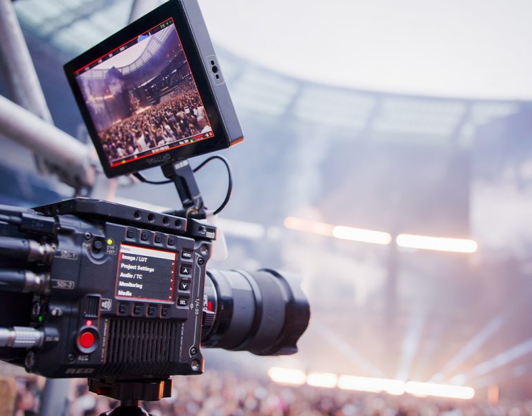 A camera recording a large crowd