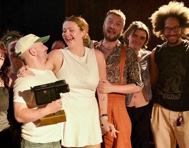 A group of people celebrating with an award