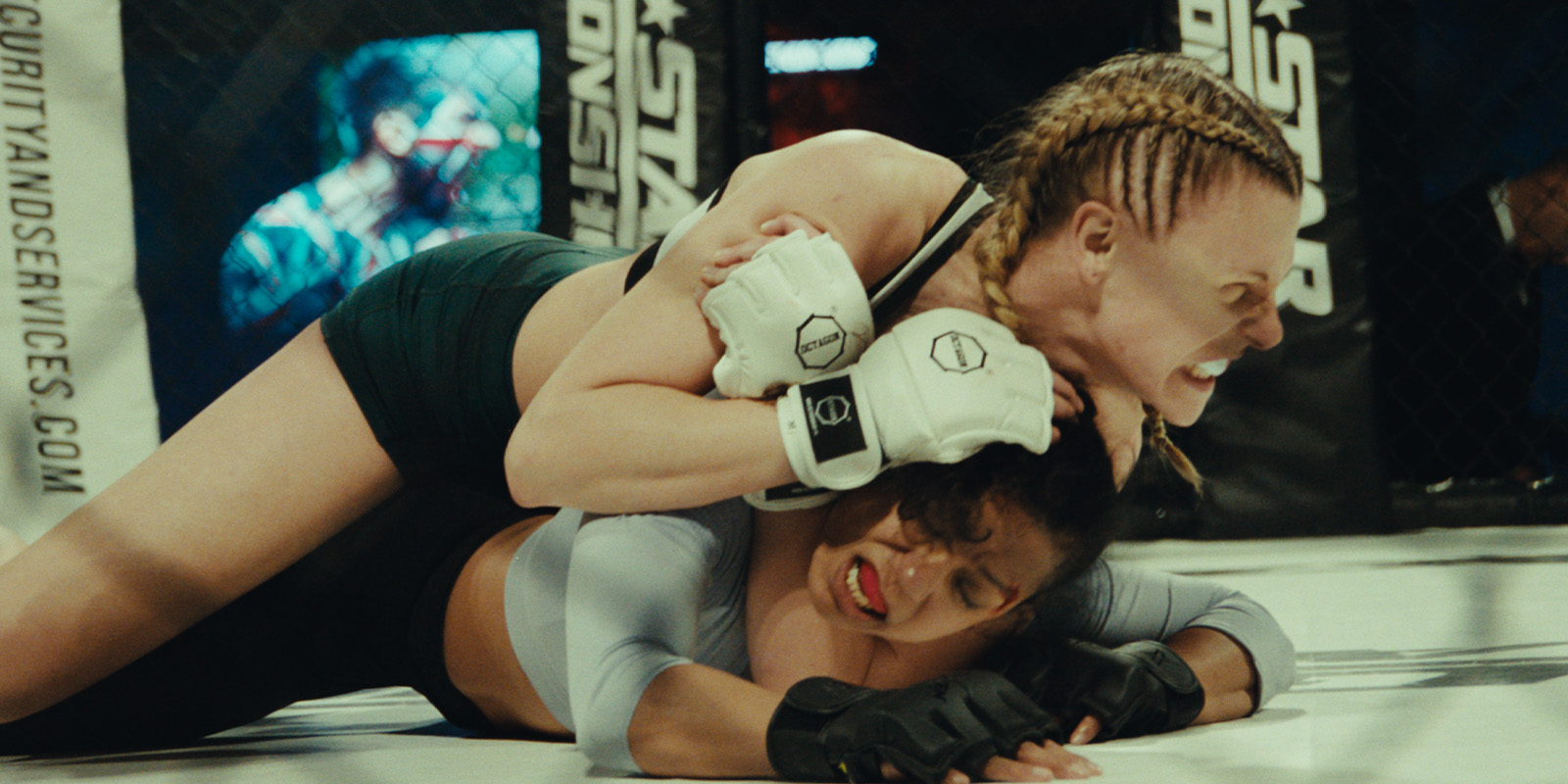 Two people fighting in an MMA fight