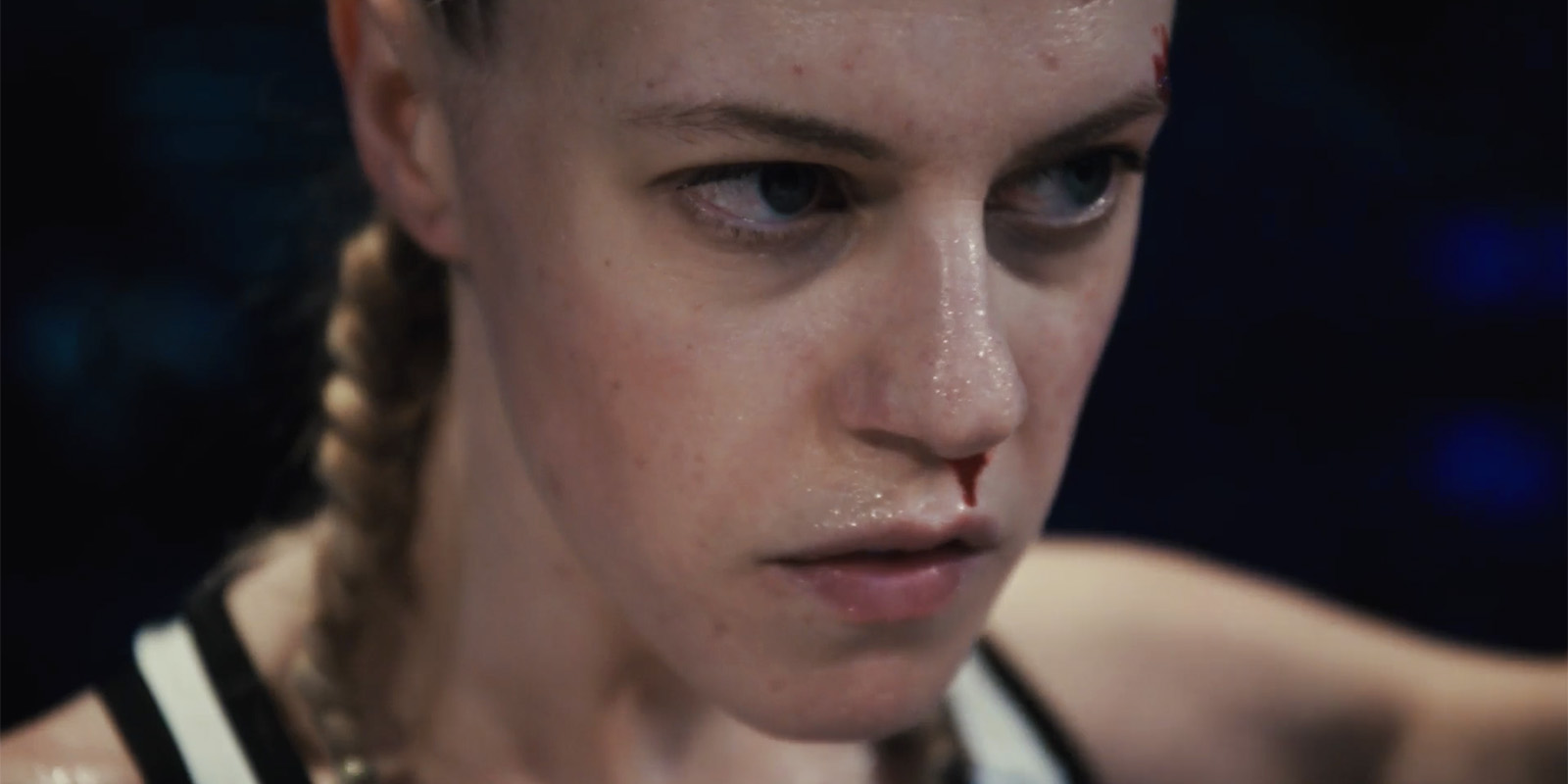 A close-up of an MMA fighter with a bloody nose
